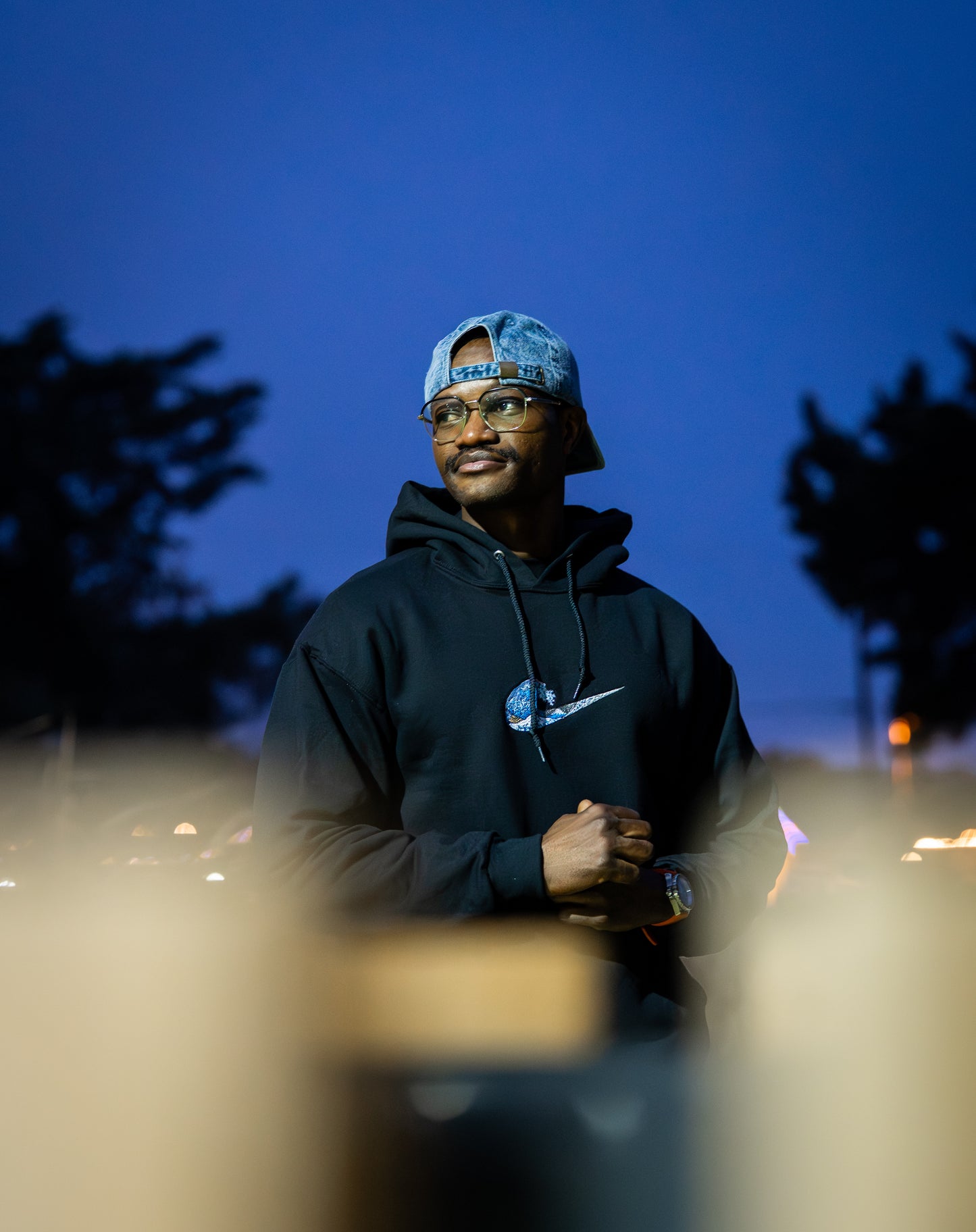 Custom wave embroidered black hoodie lifestyle photo outdoors at night — Simply Love LLC